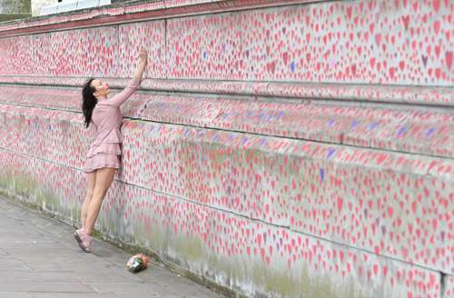 Una iniciativa de pintar corazones rojos y rosados para recordar a los fallecidosa consecuencia de la infección por el nuevo coronavirus terminó. Los voluntarios completaron un mural compuesto por al menos 150 mil corazones dibujados a mano en el National Covid Memorial Wall, en el lado sur del río Támesis en Londres. En la imagen, una participante.