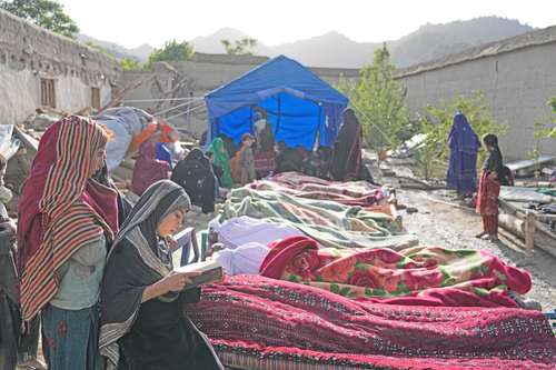 Pobladores cuidan los cuerpos de sus familiares muertos por el terremoto en la aldea de Gayan, región montañosa y escarpada.