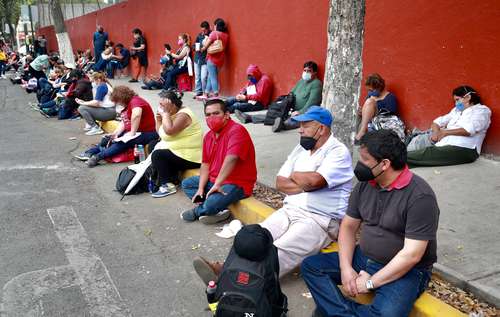 En el exterior del Colegio Madrid, varios padres esperan la salida de los participantes en el examen de admisión para la UNAM.