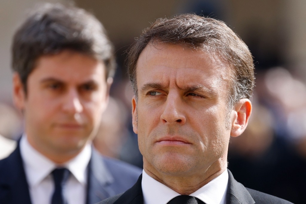 Macron asks his prime minister to proceed amid political limbo